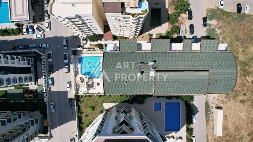 Светлые апартаменты 1+1 в премиальном комплексе района Махмутлар - Ракурс 6