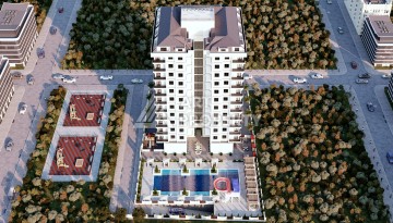 Престижная резиденция высокого качества в 150 метрах от моря в центре Махмутлара, квартиры от 55 кв.м. - Ракурс 1