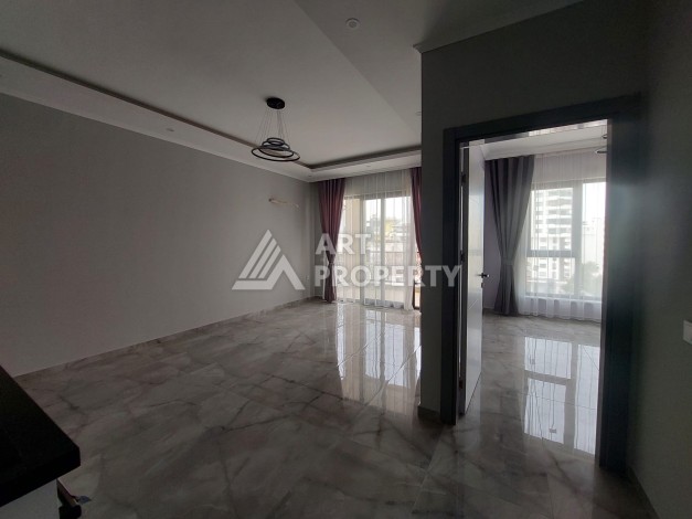 Три квартиры 1+1 в центре Махмутлара, 54-56 кв.м - Ракурс 9