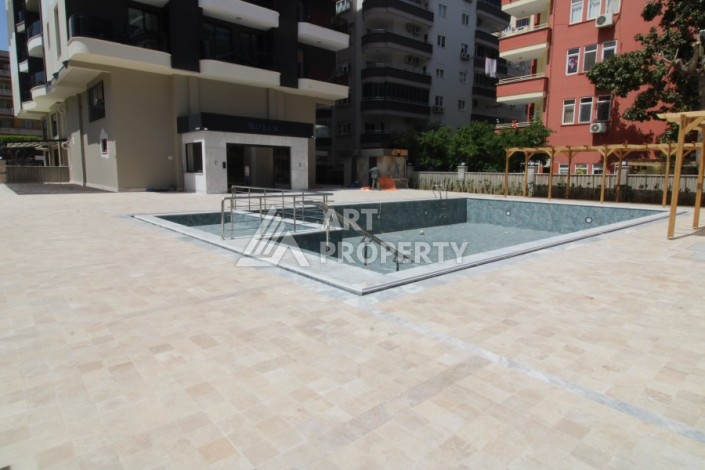 Квартира 2+1 в новом доме, 200 м до моря, в центре Махмутлара - Ракурс 3