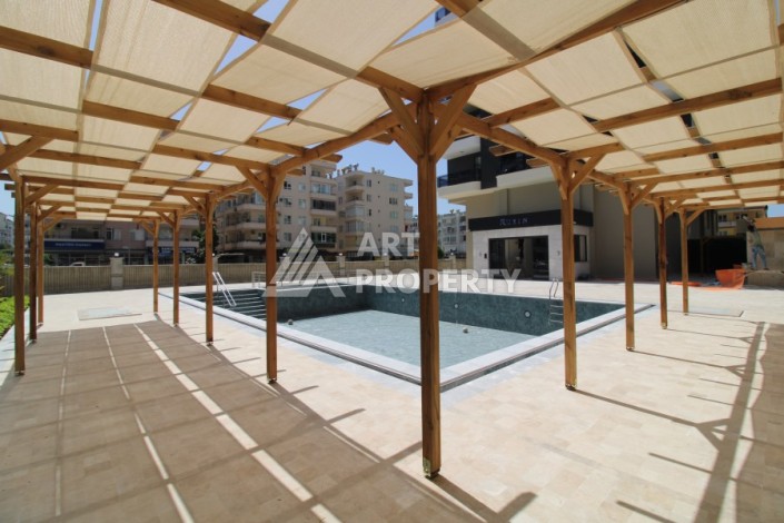 Квартира 2+1 в новом доме, 200 м до моря, в центре Махмутлара - Ракурс 4