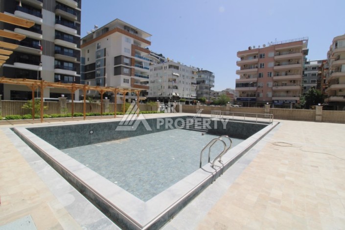 Квартира 2+1 в новом доме, 200 м до моря, в центре Махмутлара - Ракурс 5