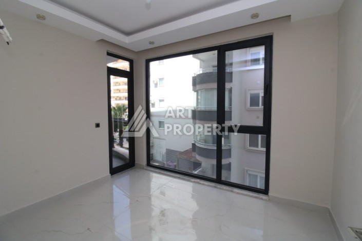 Квартира 2+1 в новом доме, 200 м до моря, в центре Махмутлара - Ракурс 18