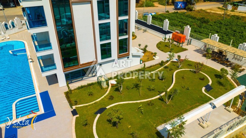 Двухкомнатная квартира 54 кв.м. в элитной резиденции. Центр района Махмутлар. - Ракурс 12