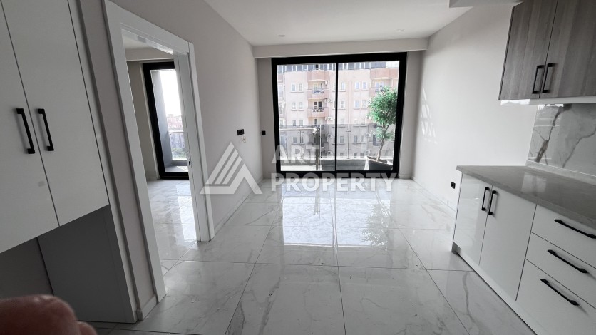 Квартира 1+1 без мебели в новом комплексе в центре Алании, всего 400 метров от пляжа Клеопатра - Ракурс 1