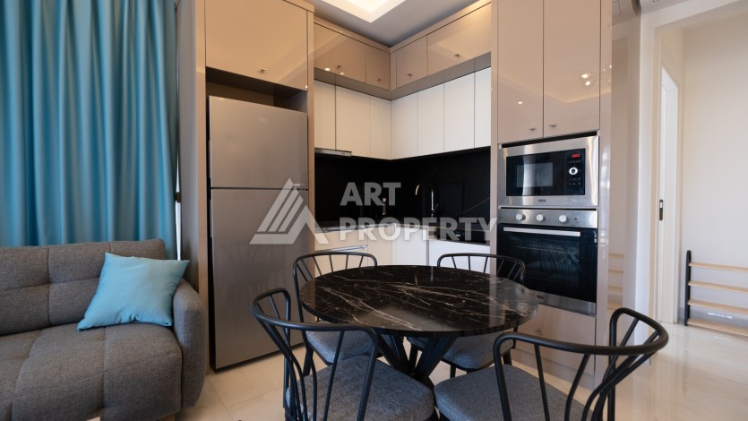 Меблированная квартира 1+1 в престижном комплексе в центре Махмутлара, 45 кв.м. - Ракурс 11