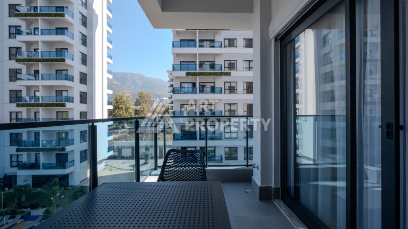 Меблированная квартира 1+1 в престижном комплексе в центре Махмутлара, 45 кв.м. - Ракурс 13