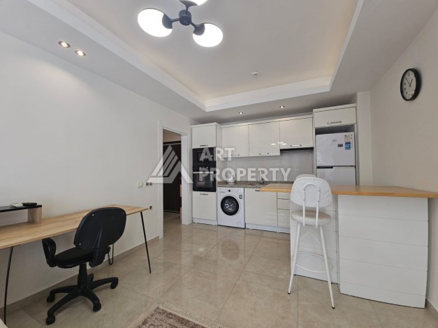 Квартира 1+1 в комплексе с отельной инфраструктурой, район Махмутлар, 500 м до моря - Ракурс 3