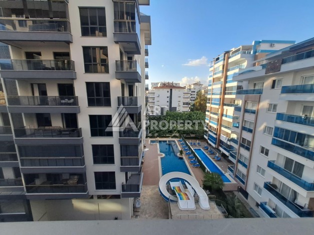 Квартира 1+1 на улице Барбаросса с боковым видом на море в Махмутларе, 55 кв.м. - Ракурс 1