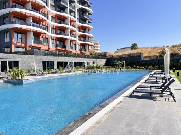 Недорогая квартира 1+1 в новом комплексе в районе Демирташ, 1200 м до моря - Ракурс 0