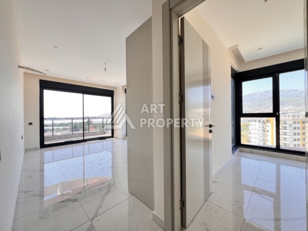 Недорогая квартира 1+1 в новом комплексе в районе Демирташ, 1200 м до моря - Ракурс 2