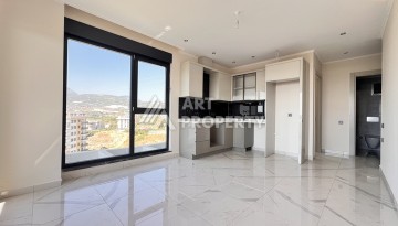 Недорогая квартира 1+1 в новом комплексе в районе Демирташ, 1200 м до моря - Ракурс 5