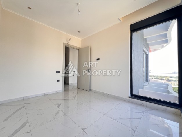 Недорогая квартира 1+1 в новом комплексе в районе Демирташ, 1200 м до моря - Ракурс 9