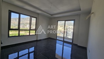 Квартира 1+1 с панорамным видом на горы в Махмутларе, 54 м², 600 м до моря - Ракурс 7