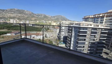 Квартира 1+1 с панорамным видом на горы в Махмутларе, 54 м², 600 м до моря - Ракурс 21