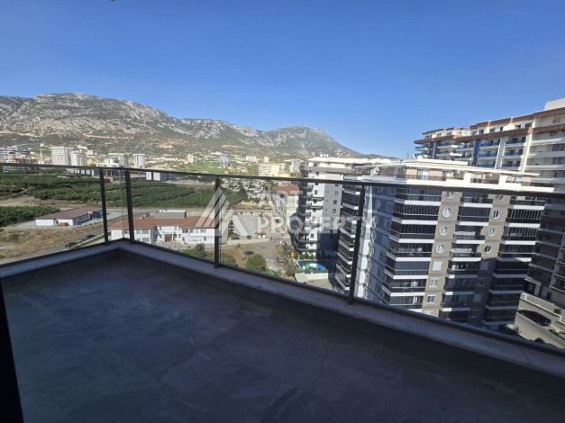 Квартира 1+1 с панорамным видом на горы в Махмутларе, 54 м², 600 м до моря - Ракурс 20