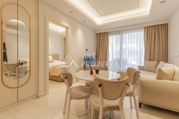 Квартира 1+1 на первой береговой линии в Махмутларе, 55 м², высокий арендный потенциал - Ракурс 1