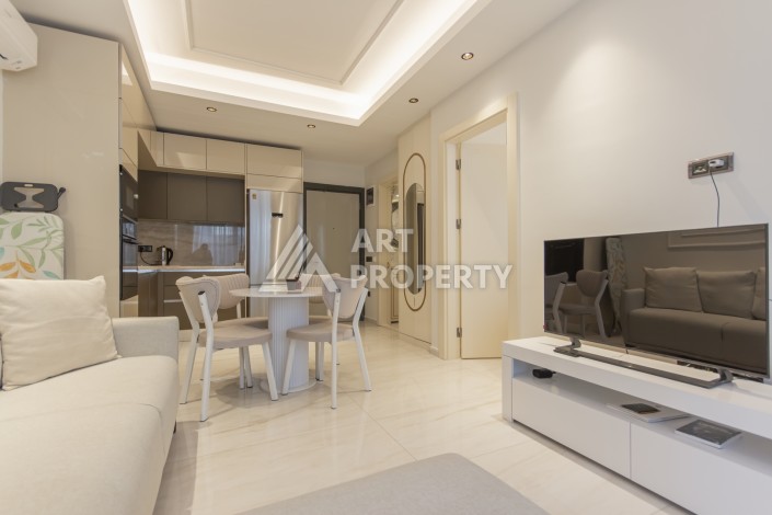 Квартира 1+1 на первой береговой линии в Махмутларе, 55 м², высокий арендный потенциал - Ракурс 5