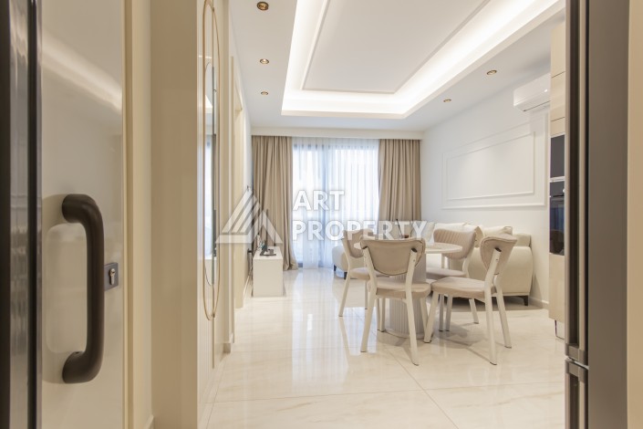 Квартира 1+1 на первой береговой линии в Махмутларе, 55 м², высокий арендный потенциал - Ракурс 6