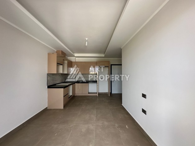 Апартаменты 1+1 в районе Махмутлар в современном жилом комплексе с полной инфраструктурой. - Ракурс 2