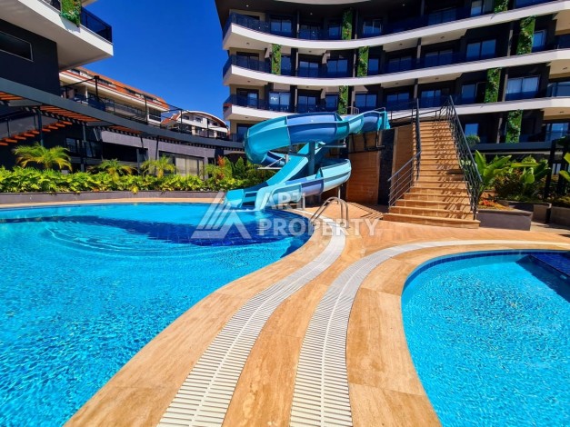 Квартира 1+1 в элитной резиденции района Оба, Алания — 55 м² с видом на бассейн - Ракурс 1