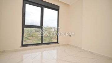 Современная квартира 2+1 с видоми на горы, море и город в современном комплексе Демирташ. - Ракурс 6