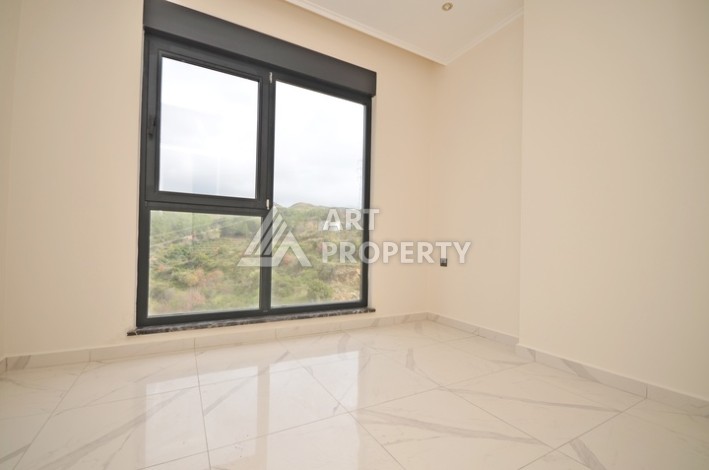 Современная квартира 2+1 с видоми на горы, море и город в современном комплексе Демирташ. - Ракурс 5