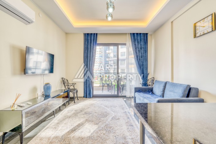 Современная квартира планировки 1+1 с мебелью и техникой в комплексе с богатой инфраструктурой в районе в Махмутларе. - Ракурс 0