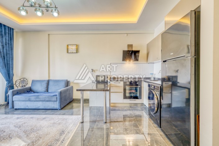 Современная квартира планировки 1+1 с мебелью и техникой в комплексе с богатой инфраструктурой в районе в Махмутларе. - Ракурс 4