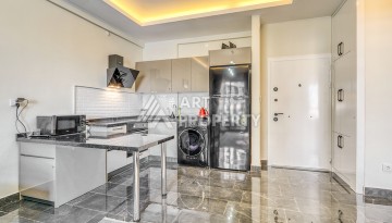 Современная квартира планировки 1+1 с мебелью и техникой в комплексе с богатой инфраструктурой в районе в Махмутларе. - Ракурс 6