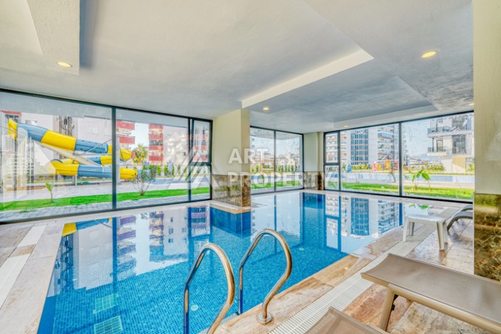 Современная квартира планировки 1+1 с мебелью и техникой в комплексе с богатой инфраструктурой в районе в Махмутларе. - Ракурс 11