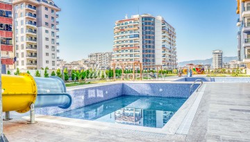 Современная квартира планировки 1+1 с мебелью и техникой в комплексе с богатой инфраструктурой в районе в Махмутларе. - Ракурс 18