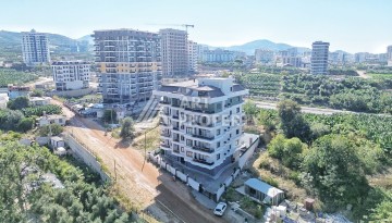 Квартира 1+1 в камерном ЖК, 55 м².   Махмутлар, Алания - Ракурс 2