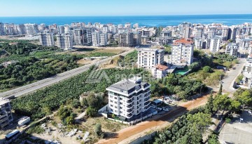 Квартира 1+1 в камерном ЖК, 55 м².   Махмутлар, Алания - Ракурс 3