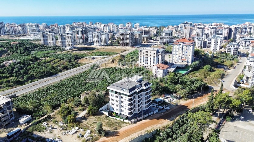 Квартира 1+1 в камерном ЖК, 55 м².   Махмутлар, Алания - Ракурс 2