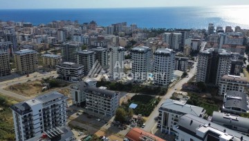 Квартира 1+1 в новом доме в центре Махмутлара, 55 м² - Ракурс 1