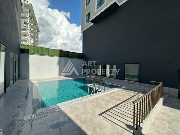 Квартира 1+1 в новом доме в центре Махмутлара, 55 м² - Ракурс 2