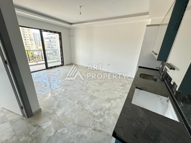 Квартира 1+1 в новом доме в центре Махмутлара, 55 м² - Ракурс 7