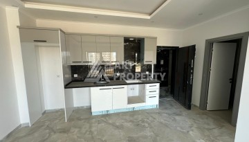 Квартира 1+1 в новом доме в центре Махмутлара, 55 м² - Ракурс 9