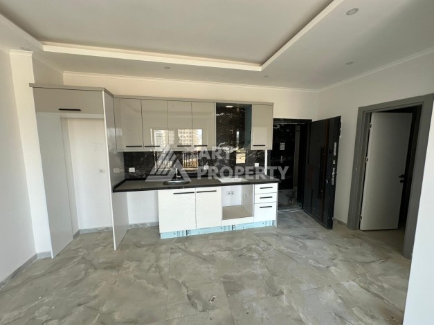 Квартира 1+1 в новом доме в центре Махмутлара, 55 м² - Ракурс 8