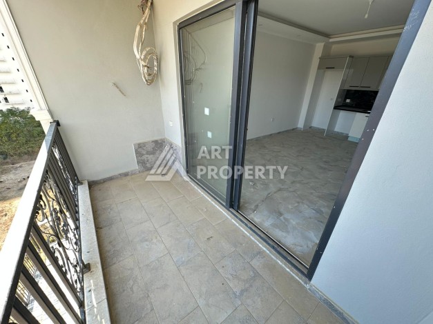 Квартира 1+1 в новом доме в центре Махмутлара, 55 м² - Ракурс 11