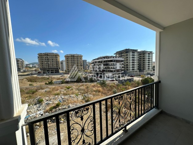 Квартира 1+1 в новом доме в центре Махмутлара, 55 м² - Ракурс 12