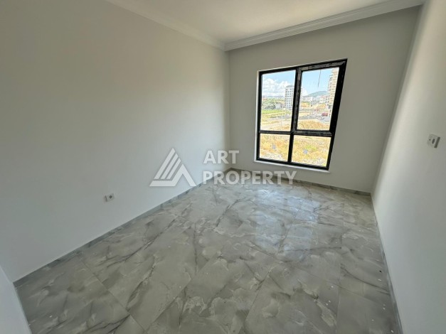 Квартира 1+1 в новом доме в центре Махмутлара, 55 м² - Ракурс 13