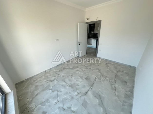Квартира 1+1 в новом доме в центре Махмутлара, 55 м² - Ракурс 14