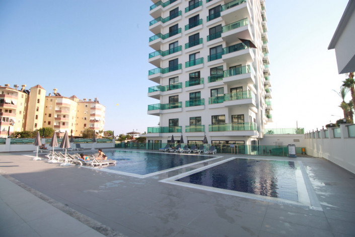 Квартиры 1+1 и 2+1 на первой линии моря в районе Махмутлар, 55 -100 м2 - Ракурс 11