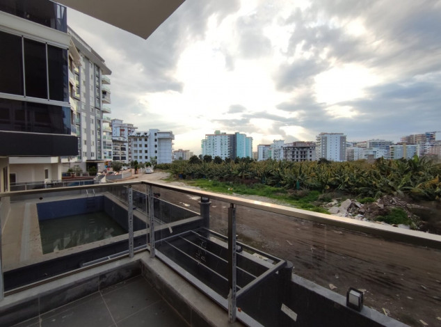 Двухкомнатная квартира в новом комплексе на побережье Средиземного моря в районе Махмутлар, 55 м2 - Ракурс 19