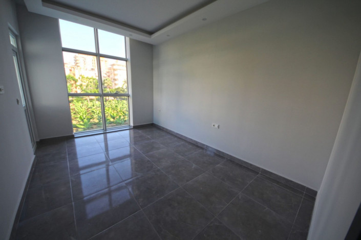 В центре района Махмутлар двухкомнатная квартира с современным ремонтом, 65 м2 - Ракурс 12