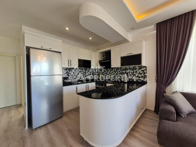 Меблированная квартира планировки 1+1 с большой площадью 70м2, район Махмутлар - Ракурс 2